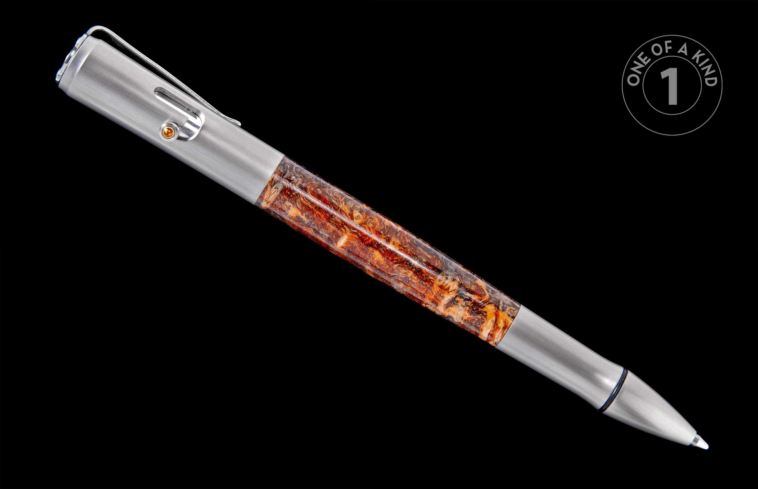 Brushed silver-toned pen with a mottled orange-brown barrel, featuring a clip and yellow accent, on a black background with a 'One of a Kind' label.