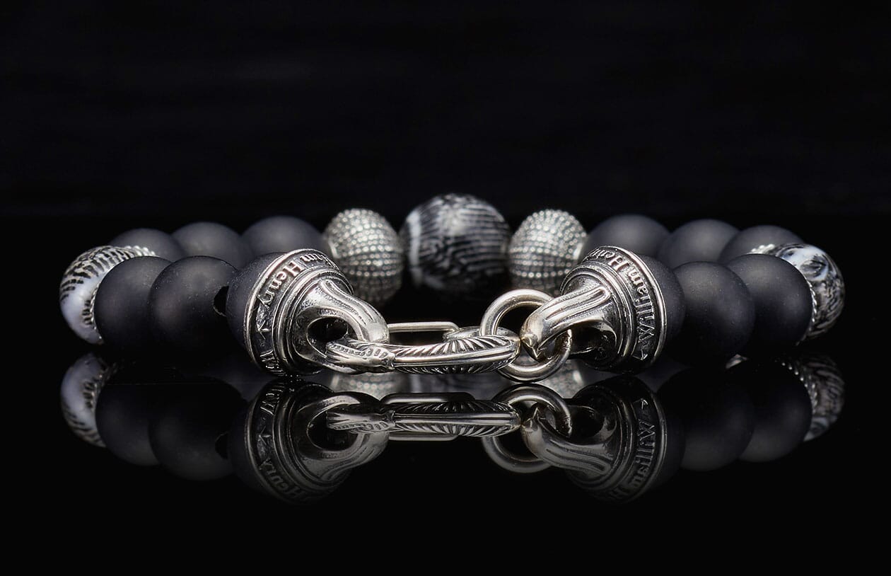 Freediver bracelet with matte black beads, silver textured and marbled accent beads, and a polished silver clasp engraved with 'William Henry'.