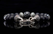 Freediver bracelet with matte black beads, silver textured and marbled accent beads, and a polished silver clasp engraved with 'William Henry'.