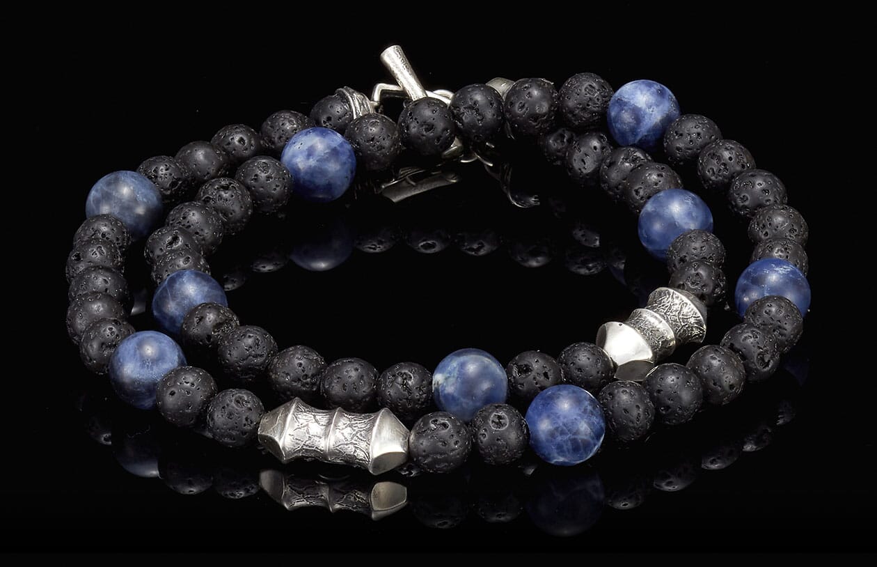 Blue sodalite and black lava stone beaded bracelet with silver-toned accents and a toggle clasp.