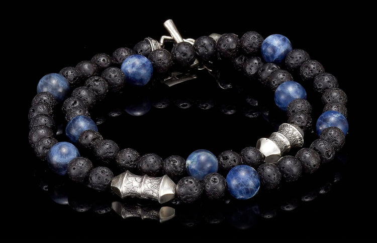 Blue sodalite and black lava stone beaded bracelet with silver-toned accents and a toggle clasp.