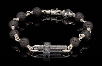 Black lava bead bracelet with silver links, a textured silver cross charm, and a silver lobster clasp.
