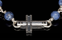 Blue sodalite beaded religious jewelry featuring a hammered silver cross centerpiece.
