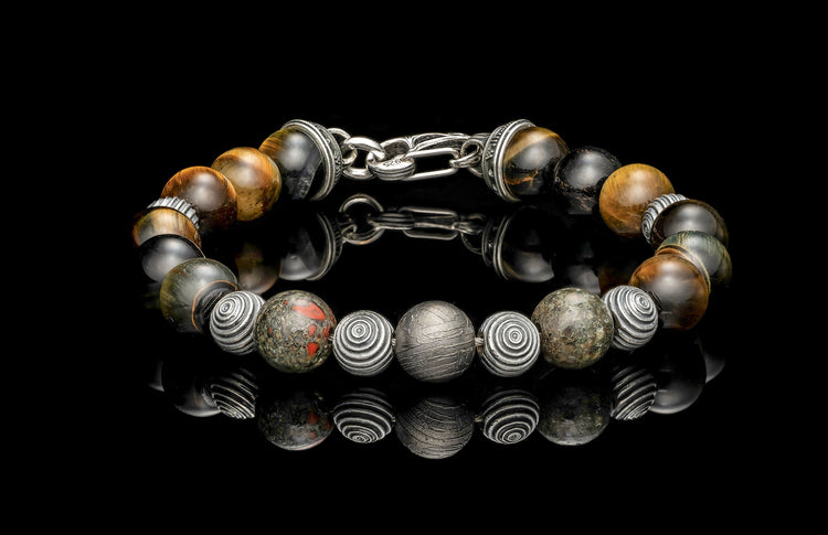 Beaded bracelet with meteorite, dinosaur bone, and Tiger's Eye beads