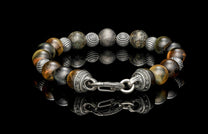 Beaded bracelet with meteorite, dinosaur bone, and Tiger's Eye beads