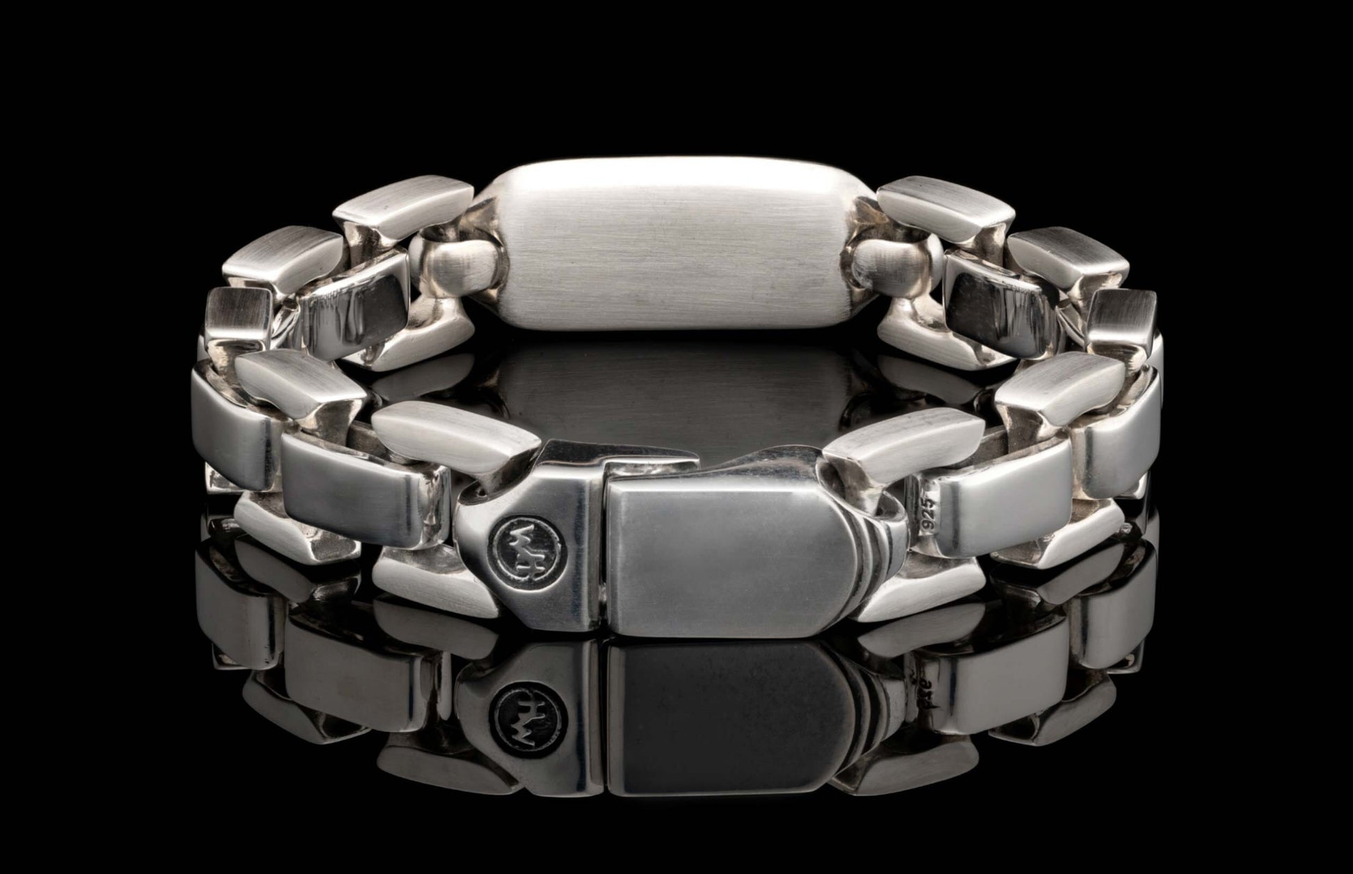Silver-toned metal bracelet with chunky rectangular links, featuring a '925' hallmark and circular logo on the clasp.