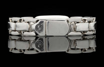 Silver identity bracelet with chunky rectangular links and a prominent clasp engraved with 'WM' and '925'.