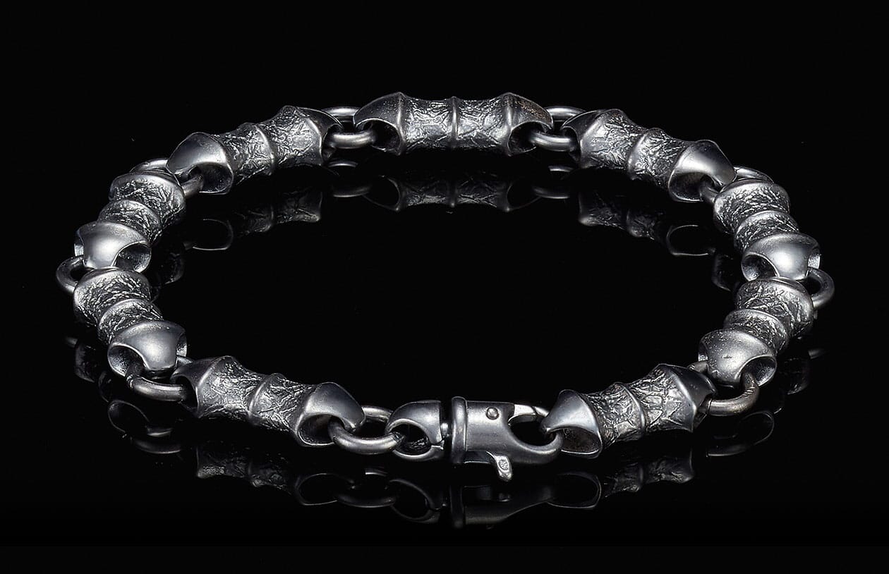 Dark silver bracelet with heavily textured, segmented links and a secure lobster clasp.