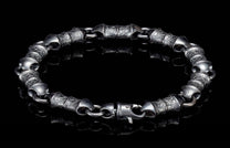 Dark silver bracelet with heavily textured, segmented links and a secure lobster clasp.