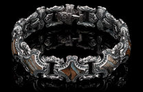 Intricate silver bracelet with brown and beige stone inlays, featuring ornate links and a secure clasp.