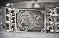 Oxidized silver bracelet featuring a roaring bear's head relief on a central plaque, linked by textured metal chains.