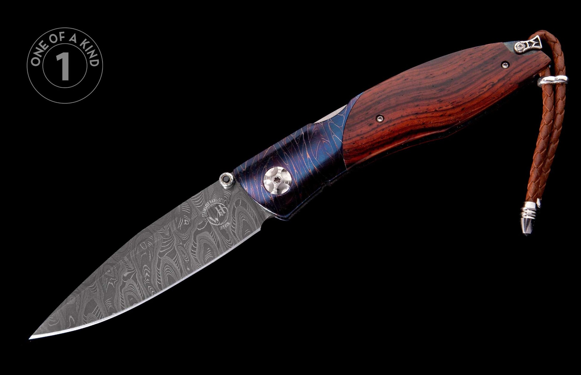 Dark wood folding knife with a patterned Damascus steel blade, blue-purple patterned bolster, and braided leather lanyard.