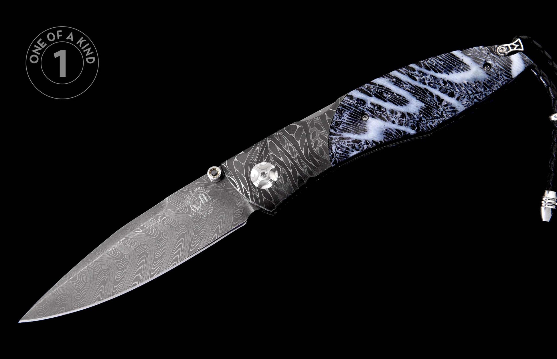 Folding knife with a dark Damascus steel blade and a black and white marbled handle, featuring a black leather lanyard.