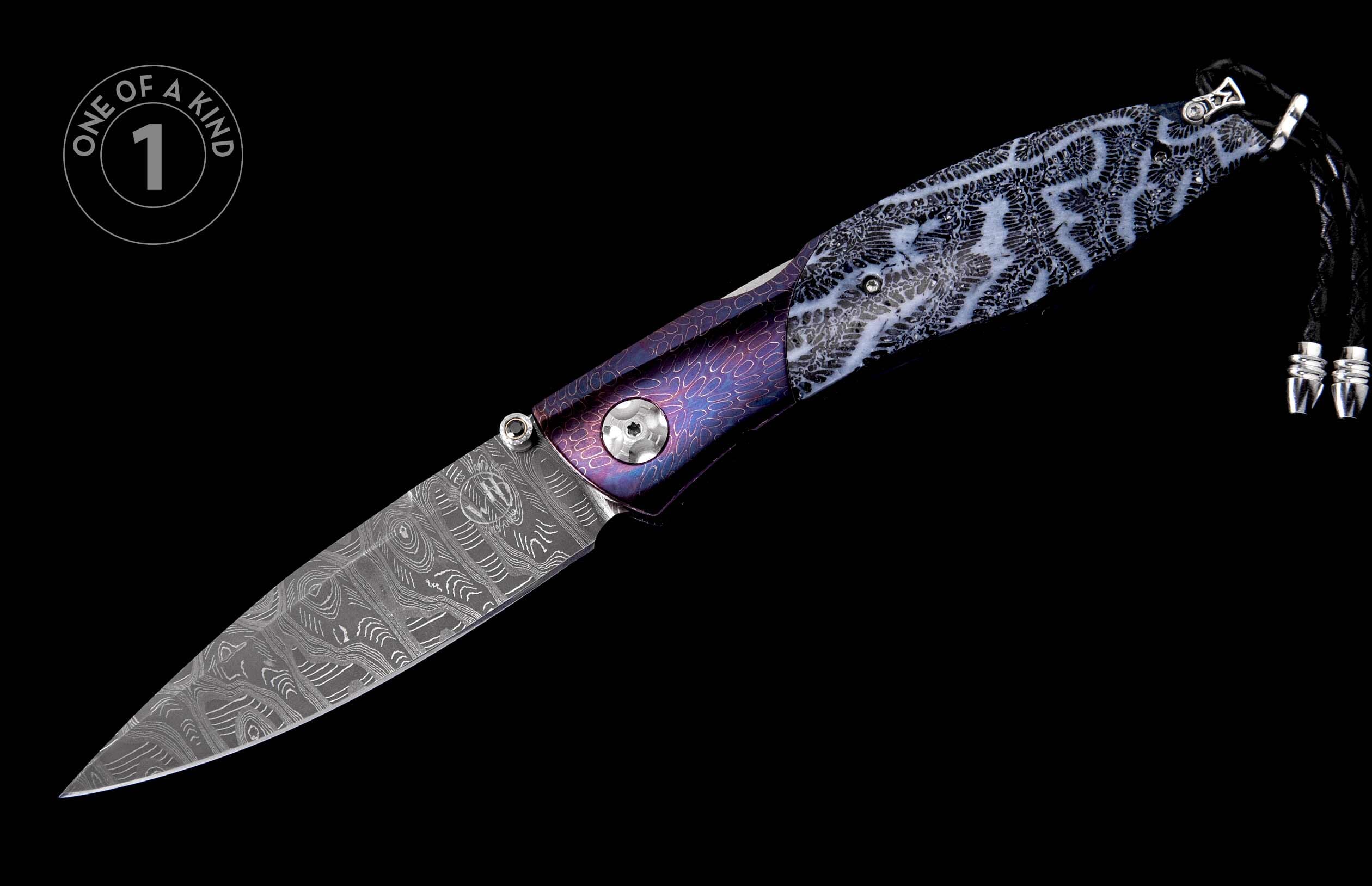 Patterned Damascus steel folding knife with an iridescent purple and white coral-like handle and a black braided lanyard.
