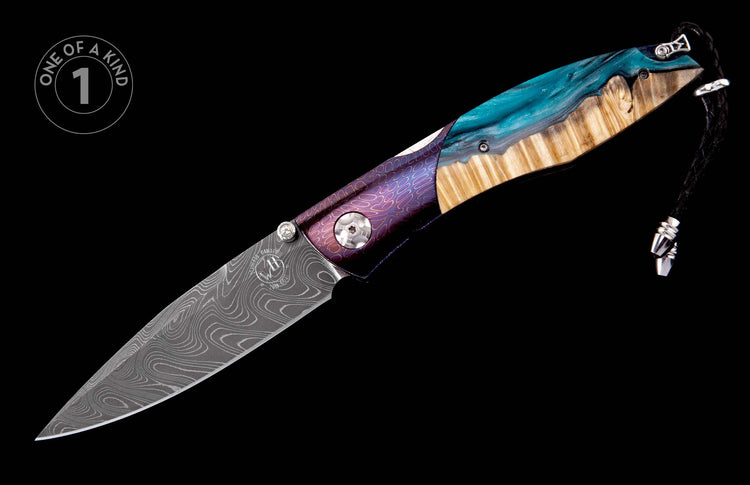 Folding knife with a patterned Damascus blade, purple etched handle, and turquoise resin and wood inlay, featuring a black lanyard.