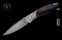 Folding knife with wavy Damascus blade, engraved silver handle featuring an eagle head, dark wood scales, and a leather lanyard.