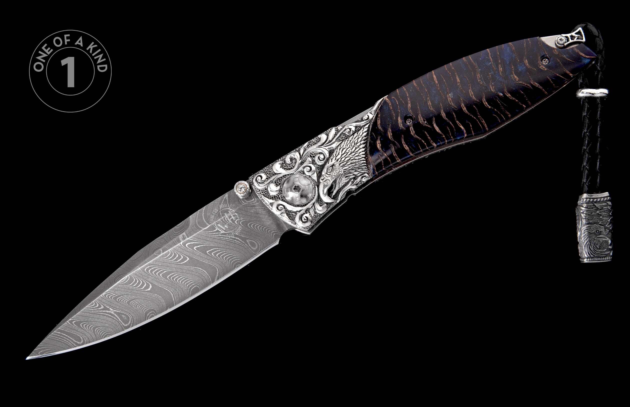 Folding knife with wavy Damascus blade, engraved silver handle featuring an eagle head, dark wood scales, and a leather lanyard.