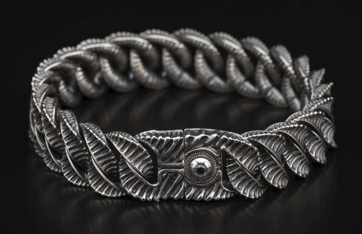 Oxidized silver bracelet with textured, organic links and a unique clasp featuring an eye design with a dark stone.