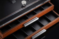 Wooden collector's box with open drawers, black leatherette compartments, brushed silver handles, and a "WH" logo knob.