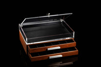 Signature collector's box with a dark wood base, clear acrylic lid, black interior lining, and two drawers with silver handles.