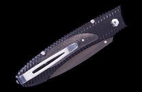 E6 3 folding knife of dark carbon fiber and metal, featuring a textured handle, silver pocket clip, and dark blade.