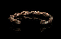 Twisted metal bracelet on a black background