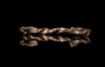 Twisted metal bracelet on a black background
