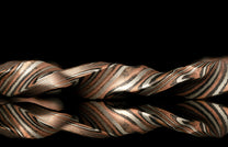 Twisted metal bracelet on a black background
