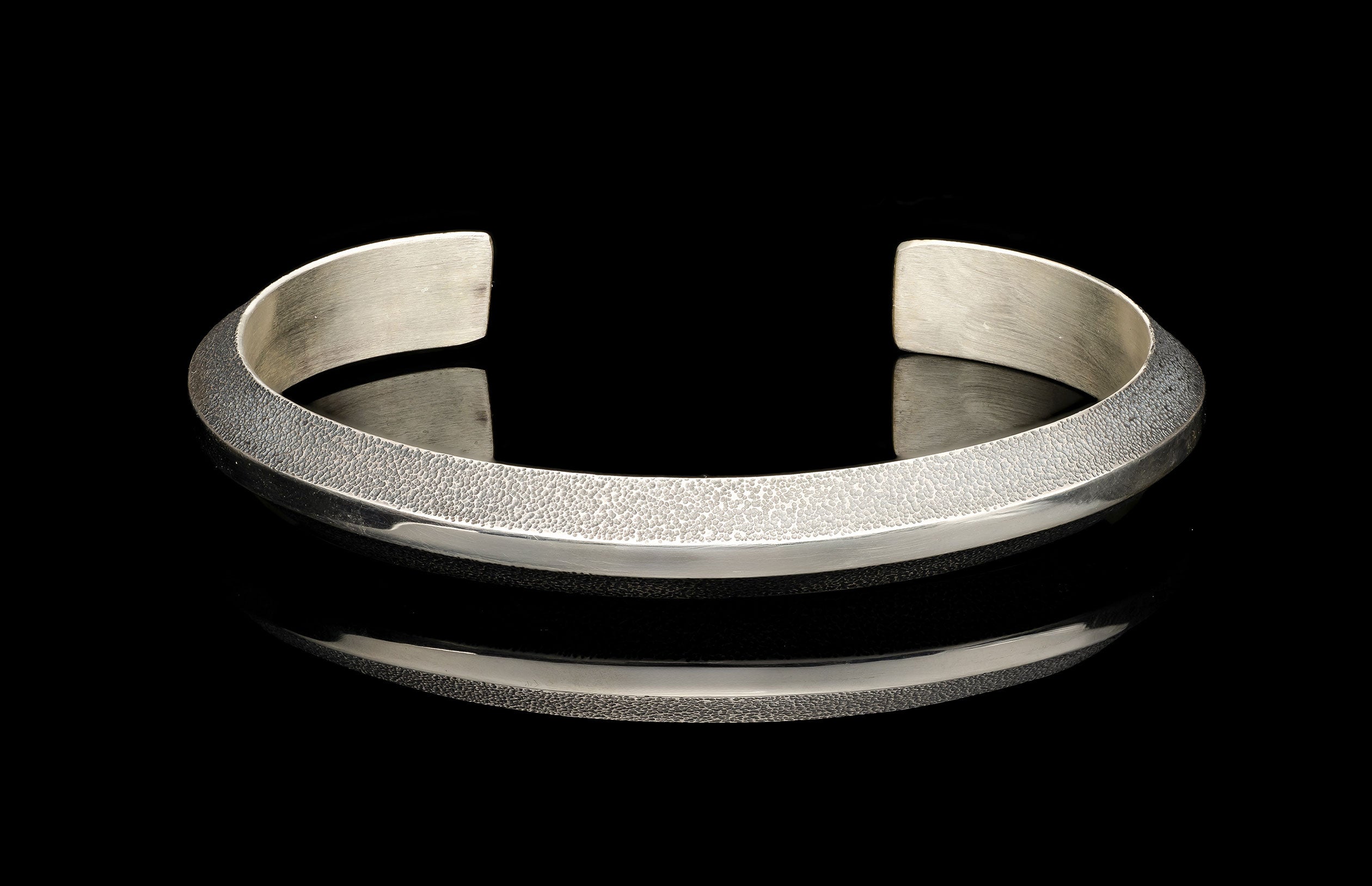 Silver bracelet on a black background