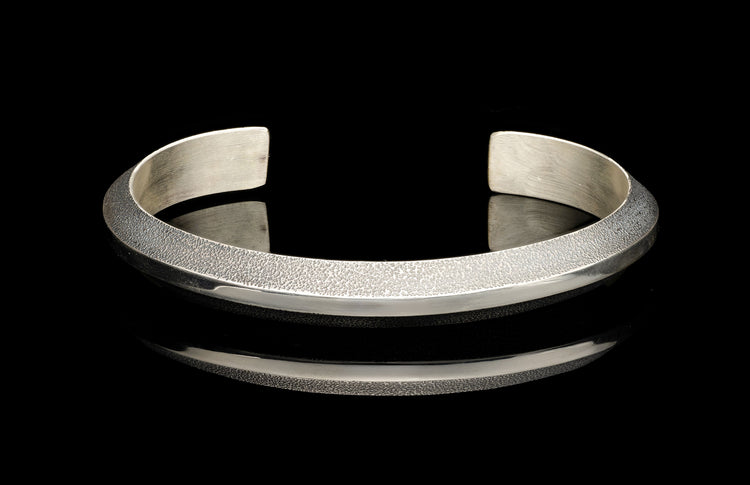 Silver bracelet on a black background