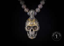 One of a kind necklace from William Henry featuring a sterling silver skull pendant with cognac gems & 23.5K gold foil on a necklace of chalcedony beads with 18K gold rondelles.