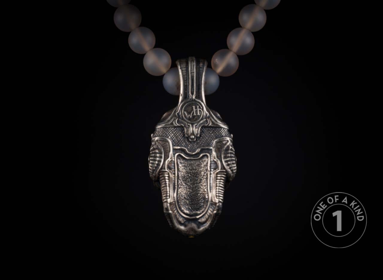 One of a kind necklace from William Henry featuring a sterling silver skull pendant with cognac gems & 23.5K gold foil on a necklace of chalcedony beads with 18K gold rondelles.