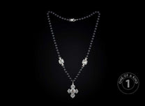 One of a kind rosary style necklace from William Henry featuring a sterling silver cross and pendants with black lip pearl inlays and faceted black onyx beads.