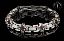 A chunky silver-toned metal bracelet with decorative cross-shaped links featuring brown patterned inlay, on a reflective black surface.