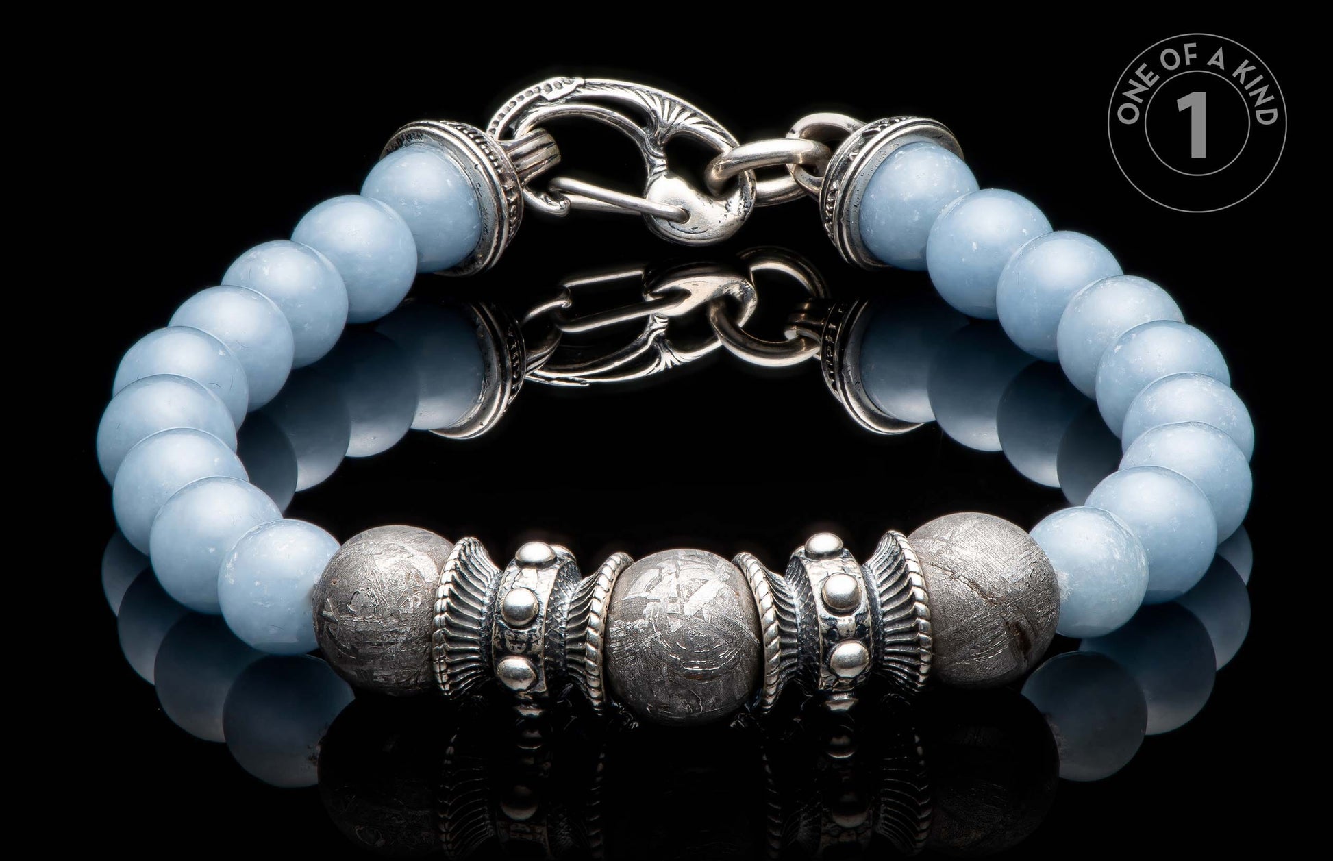 Light blue beaded bracelet with textured silver-toned beads, ornate metal spacers, and an intricate hook clasp.