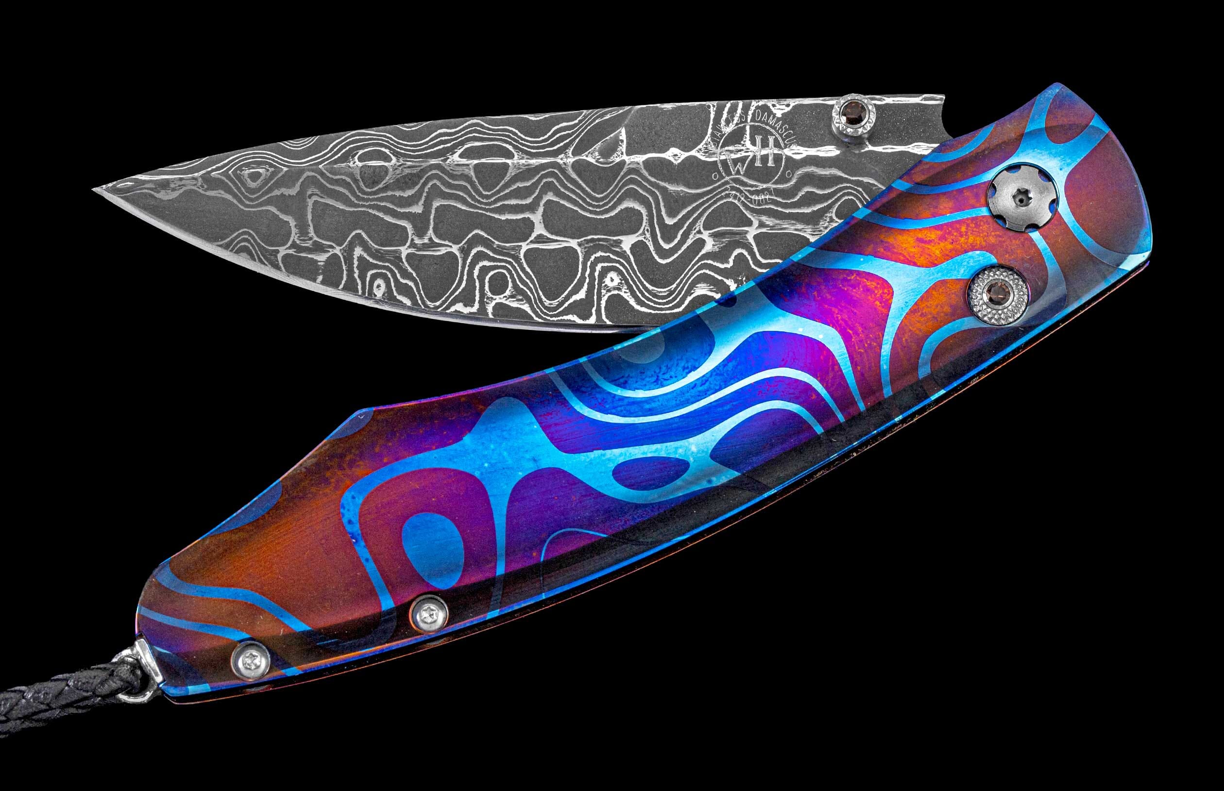 Partially open folding knife with a patterned Damascus blade and a vibrant blue, purple, orange swirled handle with a black lanyard.