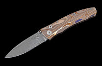 William Henry pocket knife featuring Laser color-engraved titanium frame and hand forged damascus steel blade