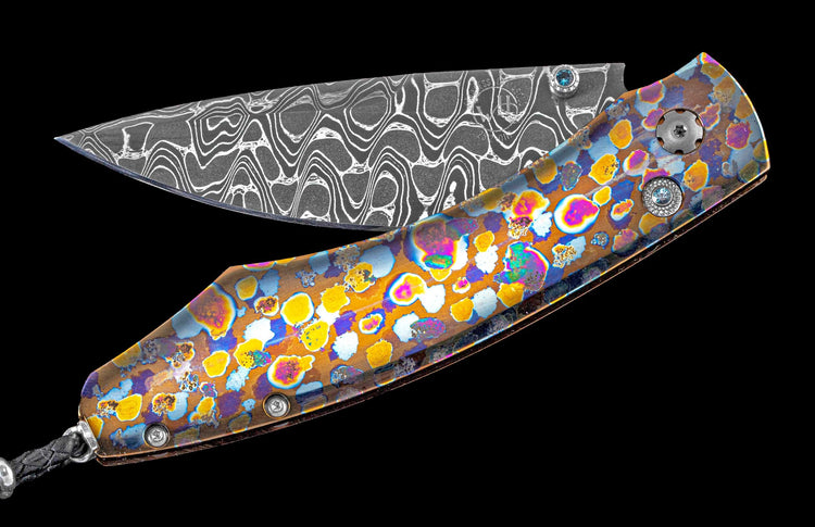 Brightly colored one of a kind William Henry knife featuring a laser colored titanium frame and hand forged damascus steel blade