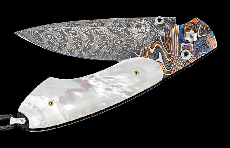 One of a kind William Henry custom knife with hand forged Damascus steel, Laser engraved titanium, Mother of pearl, and Spinel gemstones.