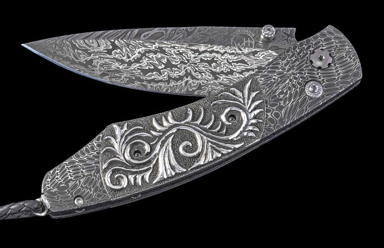 One of a Kind William Henry Custom Knife with damascus steel frame, carved sterling silver scales, and damascus blade.