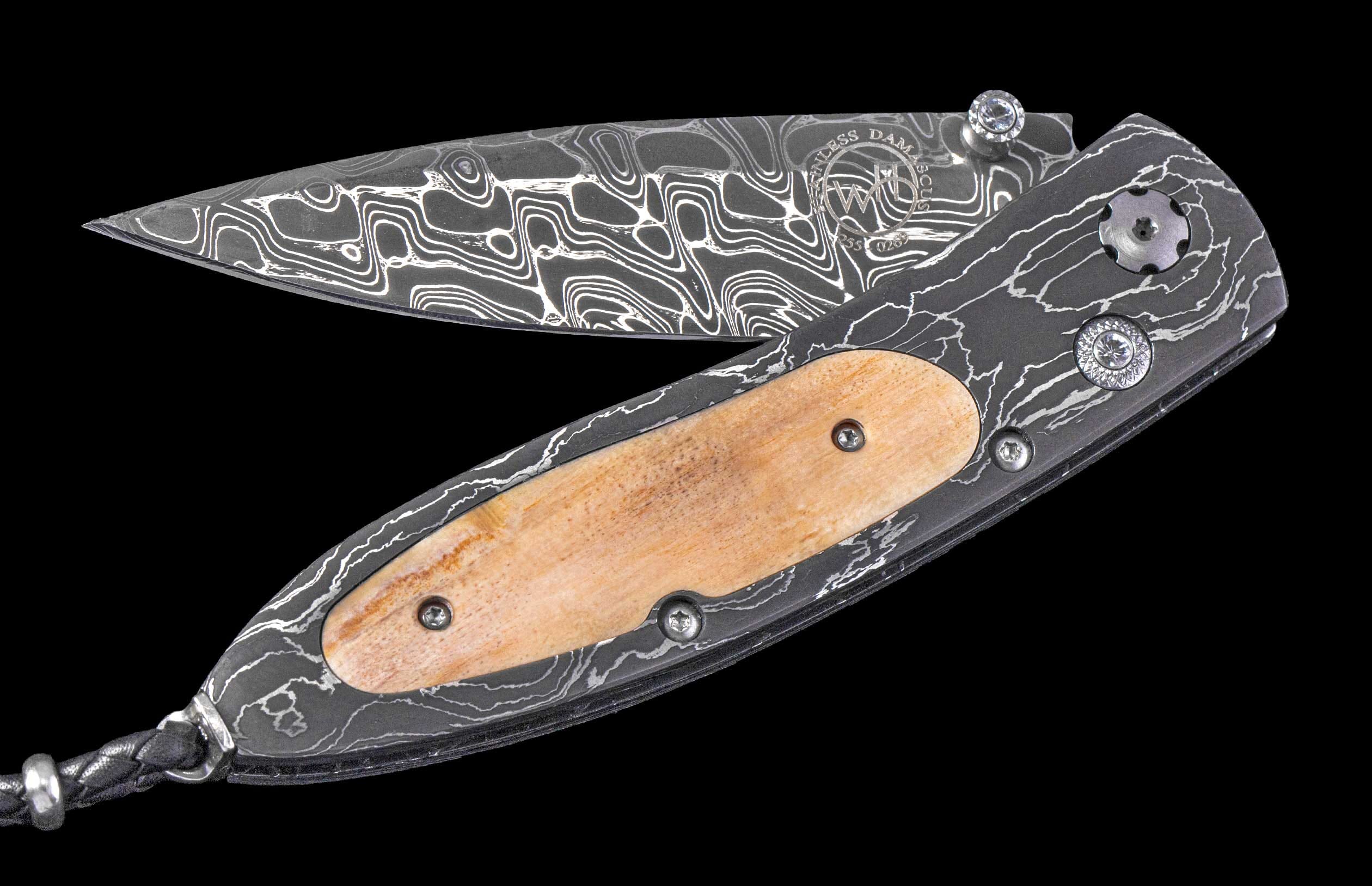 Partially open knife with patterned Damascus steel blade, dark lightning-patterned handle, light wood inlay, jeweled screws, and a black braided lanyard.