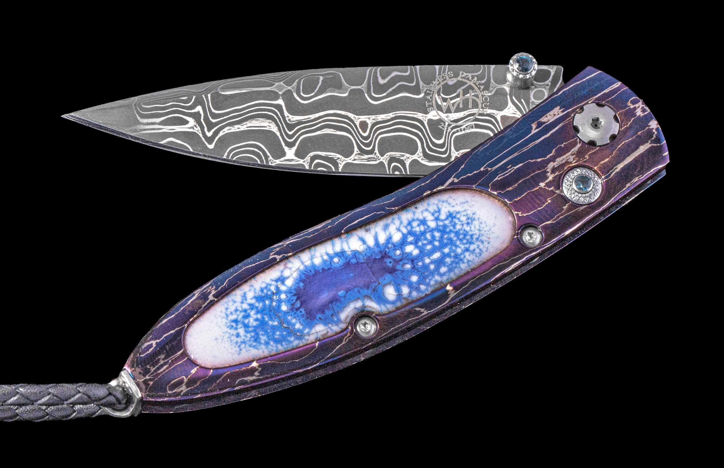 One of a William Henry Custom Knife with Heat-blued damascus frame, enamel scales, Blue topaz gems, and damascus steel blade