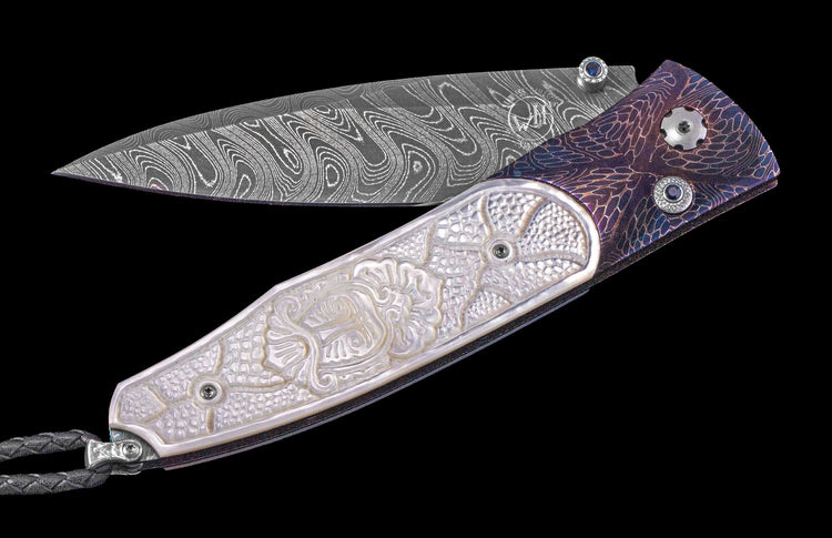One of a Kind William Henry Custom Knife with Heat-blued 'Mind Melt' damascus frame, Hand-carved mother of pearl scales, sapphire gems, and damascus steel blade.