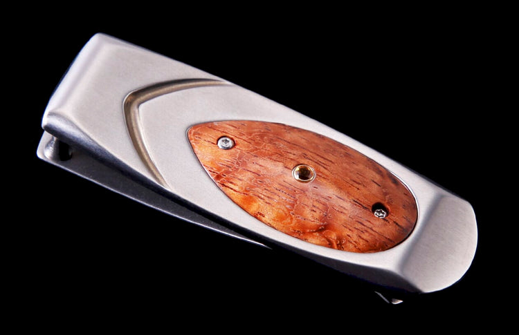 Silver-toned money clip by Geneva, featuring an oval reddish-brown wood inlay with textured grain and small metallic fasteners.
