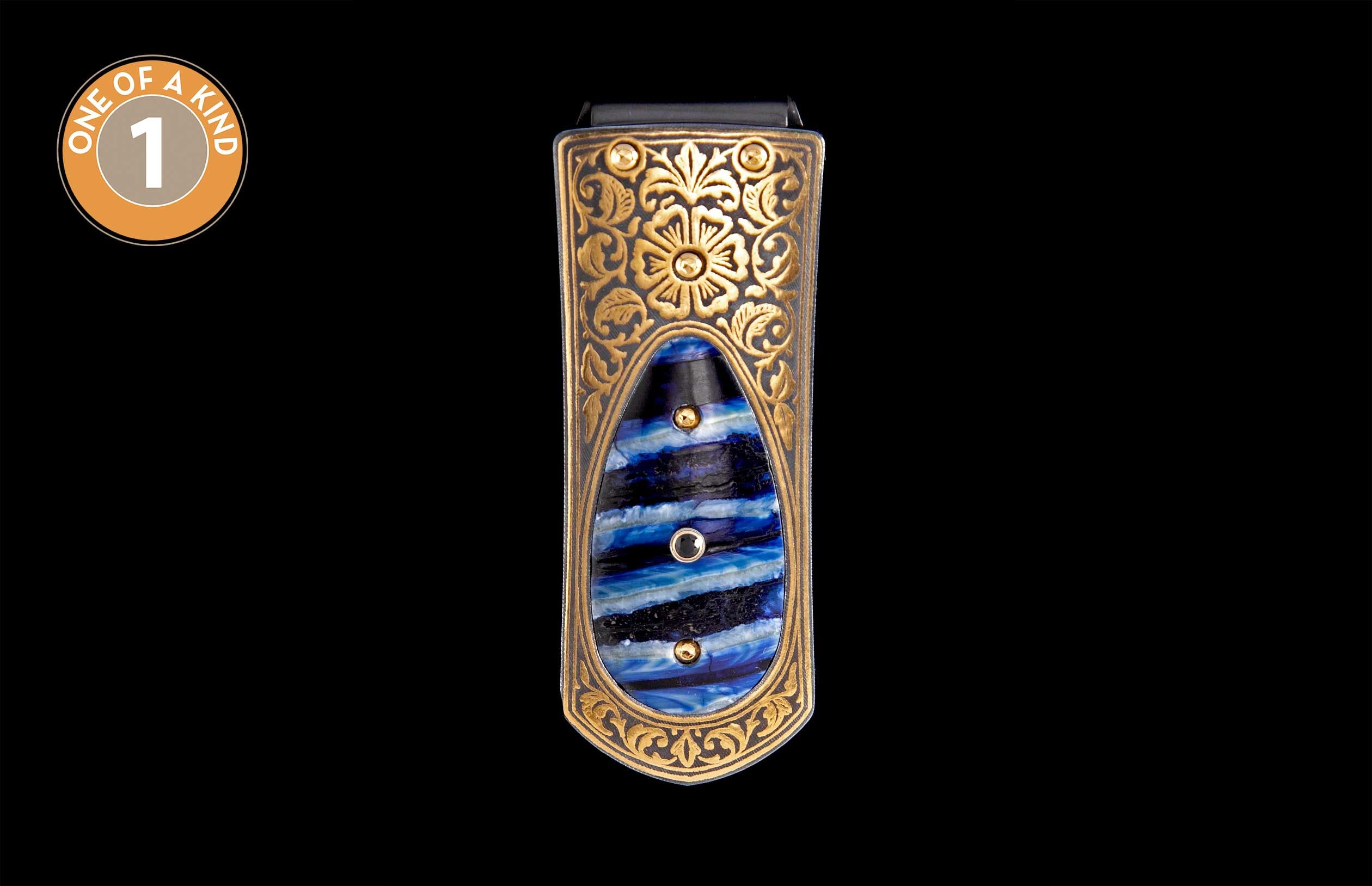 Gold-toned money clip with ornate floral engraving and a central blue and black striped inlay.