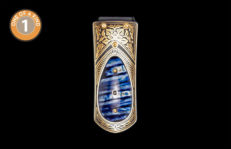 Black money clip with ornate gold scrollwork and a blue and white striped inlay, accented with studs.