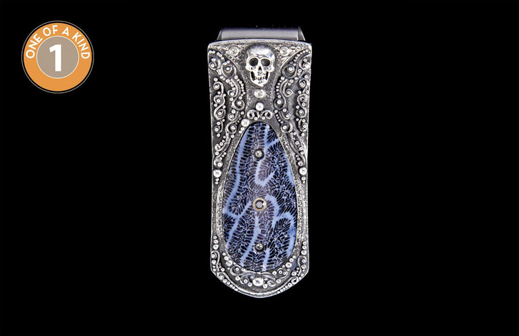 Ornate silver-toned money clip featuring a skull detail and a blue and white patterned stone.