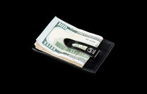 MCW MC BLK|Black leather Card & Cash Wallet holding hundred-dollar bills, with a black money clip featuring a logo and #00306, angled.