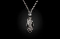 Silver-toned braided necklace featuring a detailed crocodile head pendant with an open mouth, connected by an ornate bead.