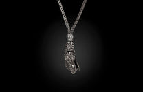 Silver braided necklace with an intricate dragon head pendant featuring scales.